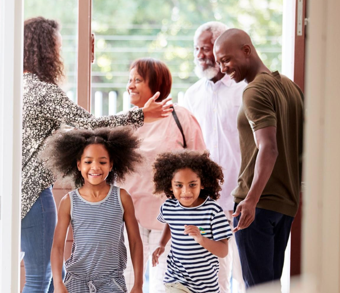 family members being greeted inside the front door